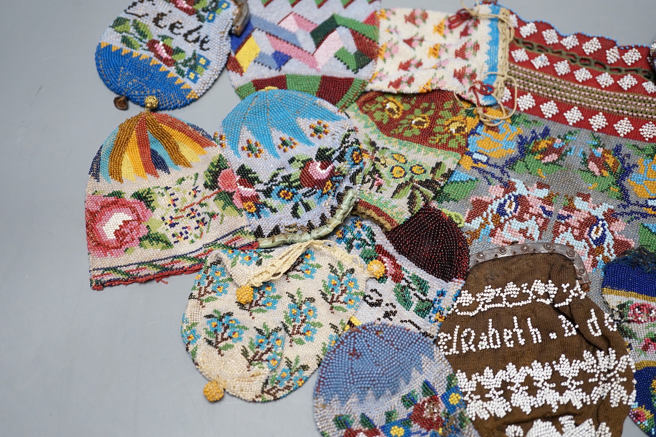 Three Victorian beadwork bags, circa 1860, largest 17cm high, and a collection of eleven smaller reticules and purses